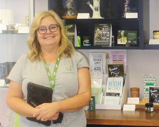 Wendy Thompson shows off various accessory products for sale in the store. Photo/Craig Bakay